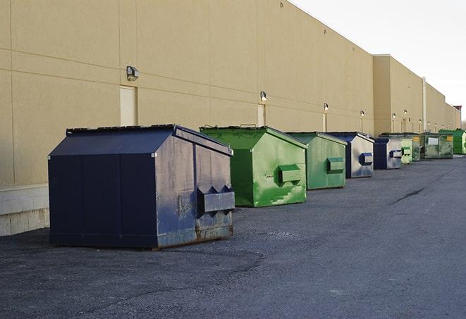 a pile of demolition waste sits beside a dumpster in a parking lot in Albany WI